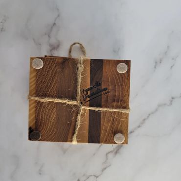 Square wooden board tied with twine on a marble surface.