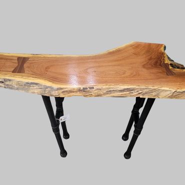 Live edge wooden table with metal legs.