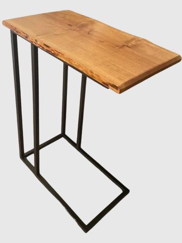Modern side table with wooden top and black metal frame.