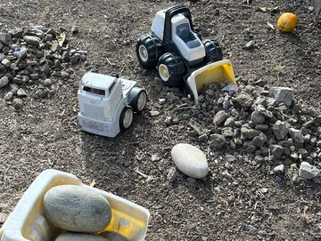 Toy trucks with rocks and dirt