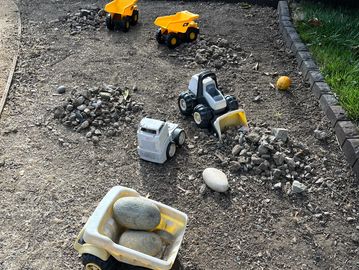 Toy trucks with rocks and dirt
