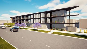 Modern, angular apartment building with balconies and street parking under a blue sky.