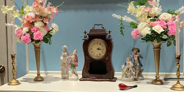 Set dressing including an antique clock and flower arrangements for Dei Fledermaus, Western Opera