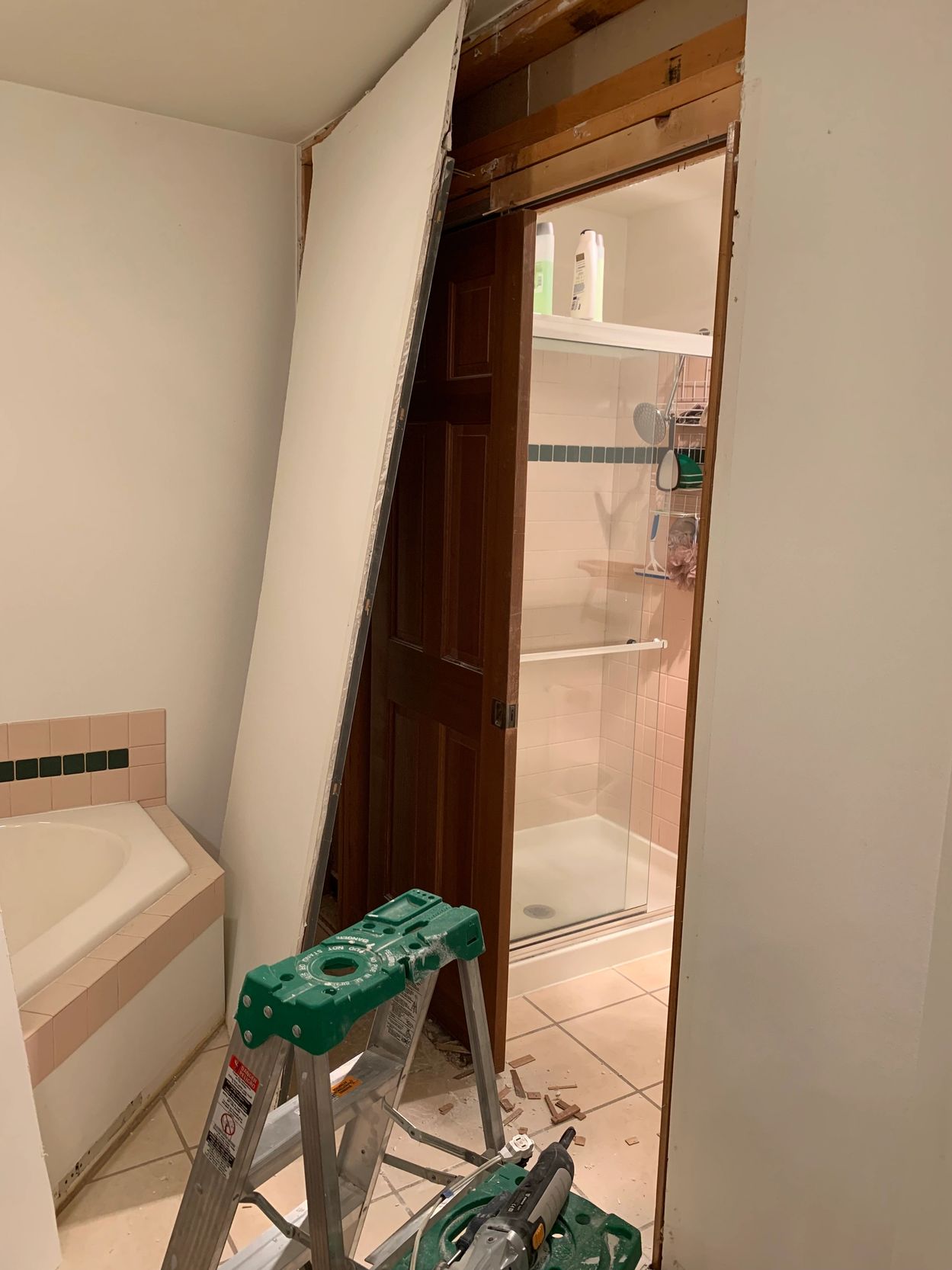 Bathroom wall repair with drywall panel removed.
