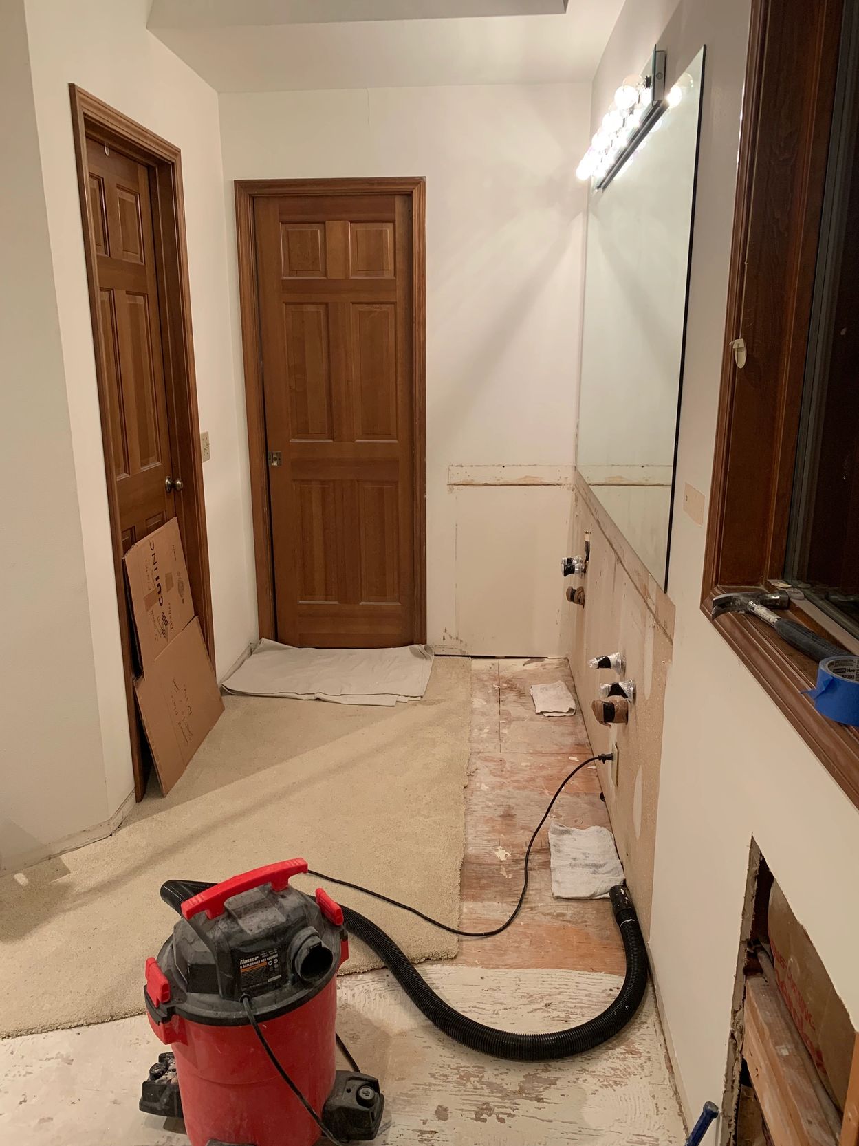 Room under renovation with tools and wooden doors.