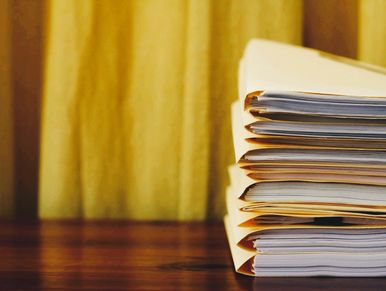 Stack of folders standing on table