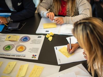 People sitting on table writing