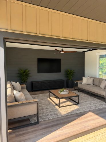 Custom outdoor entertainment space featuring a professionally mounted TV, in-ceiling speakers, and a
