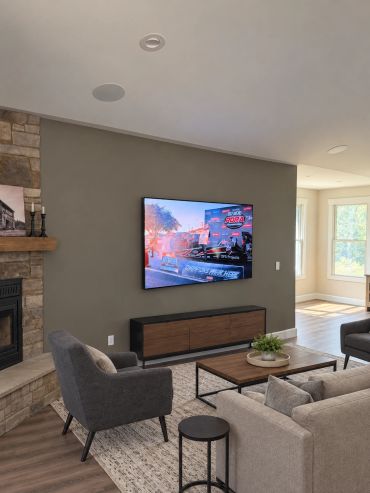Professionally mounted TV with concealed wiring and in-ceiling speakers, creating a clean and comfor