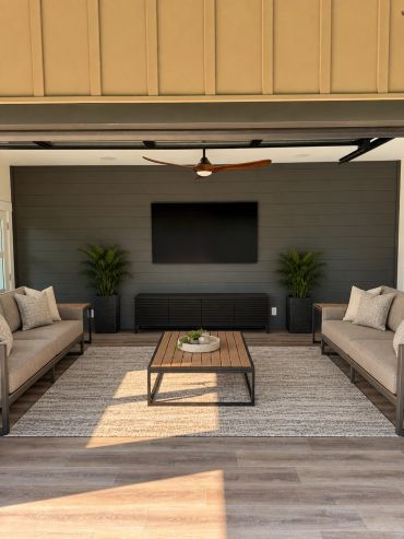 Custom outdoor entertainment space featuring a professionally mounted TV, in-ceiling speakers, and a