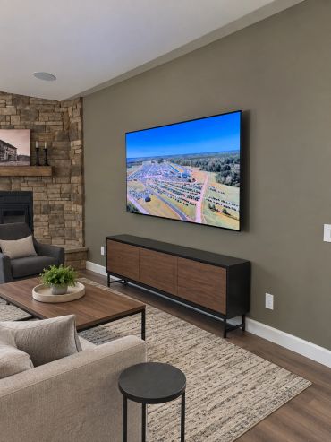 Professionally mounted TV with concealed wiring and in-ceiling speakers, creating a clean and comfor