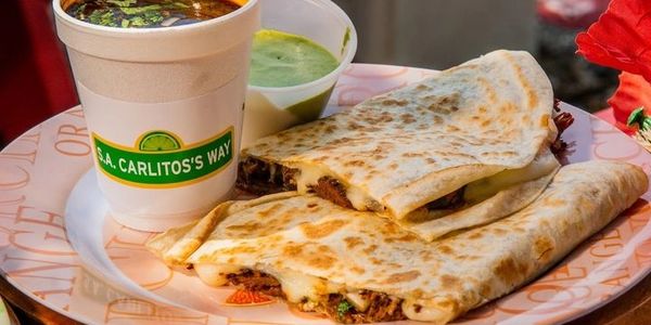 Birria Quesadilla plain Consommé and our half avocado cilantro lime dip half crema & house sauce.