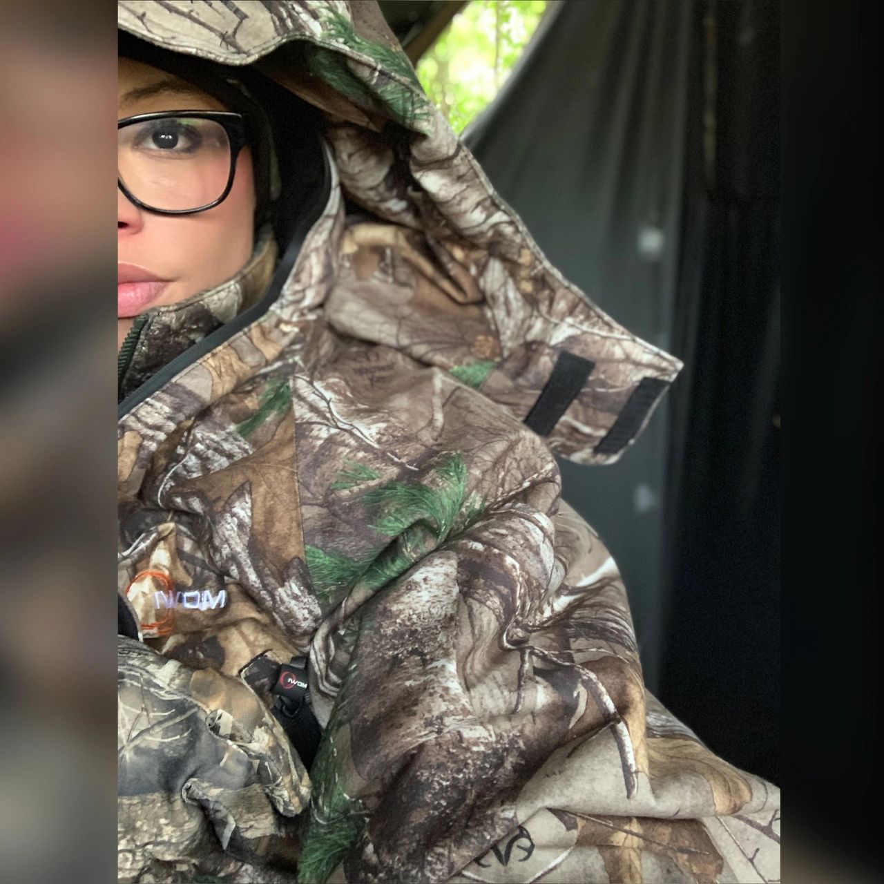 girl in glasses wearing military camo merch