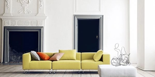 Modern living room with a yellow sofa and minimalist decor.
