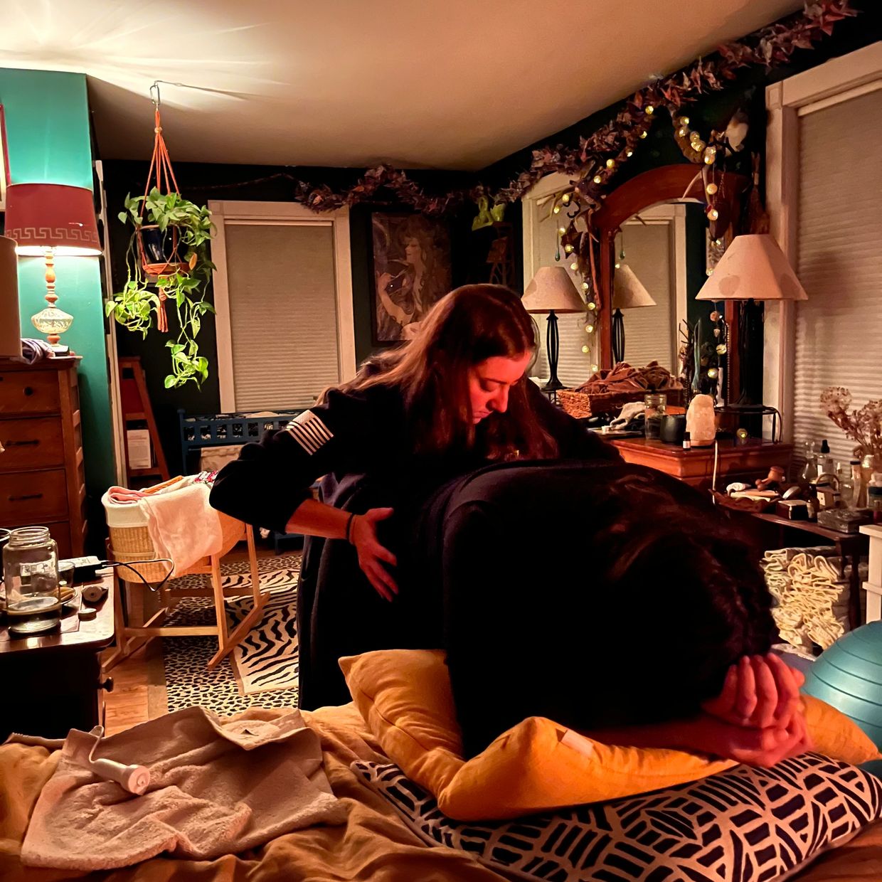A person receiving a back massage in a cozy room.