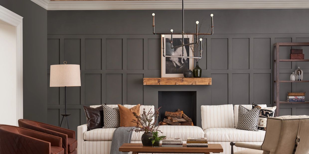 Cozy living room with dark paneled wall and neutral-toned furniture.