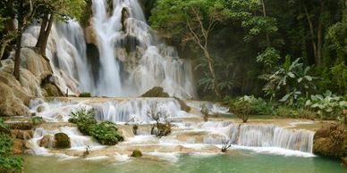 A waterfall and a shallow pool under the waterfall in Kuang Si, Cambodia.