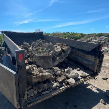 Dump truck loaded with concrete rubble.
