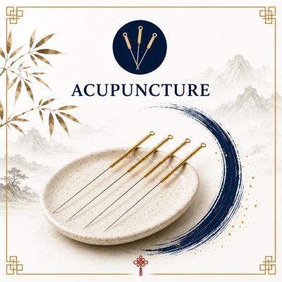 Four acupuncture needles on a white plate with decorative background.
