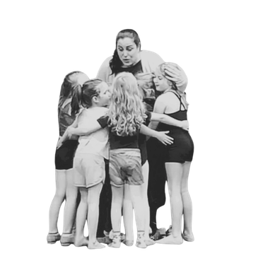 Picture of Angela Gratton in a huddle with young dancers