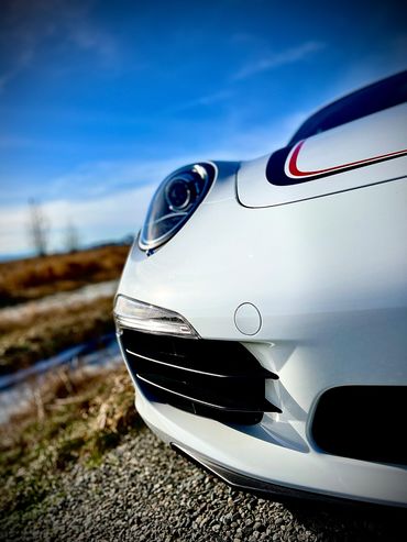 Close-up of a white sports car front.