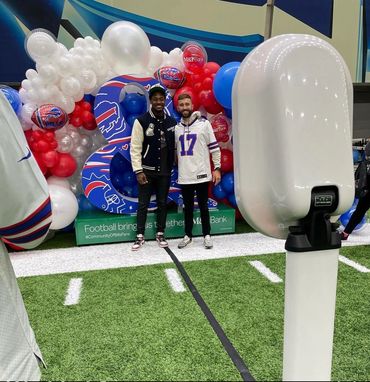 White digital photo booth on a Buffalo Bills football field for a corporate event.