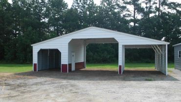 Large white and maroon metal carport with multiple bays and a side door.