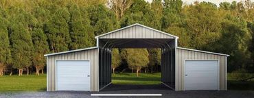 Metal carport with dual enclosed garages on each side in a green wooded area.