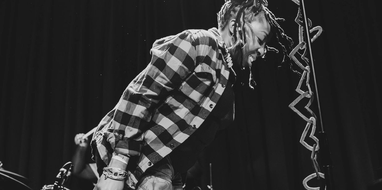 Musician passionately performing on stage in black and white.