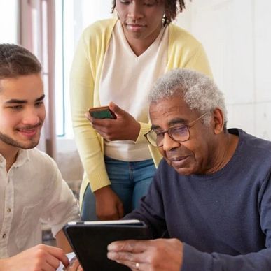 Three generations interacting with a tablet.