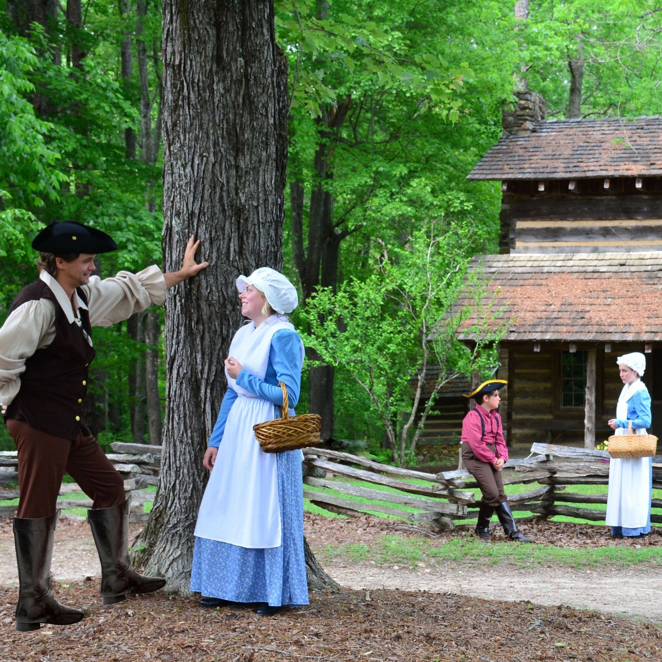 People in colonial attire interact outdoors near log cabins in a lush green setting.