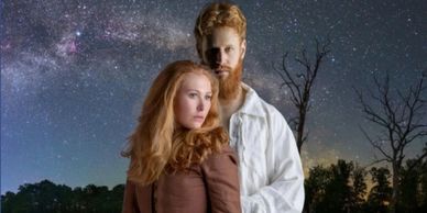 A couple with red hair stands under a starry night sky.