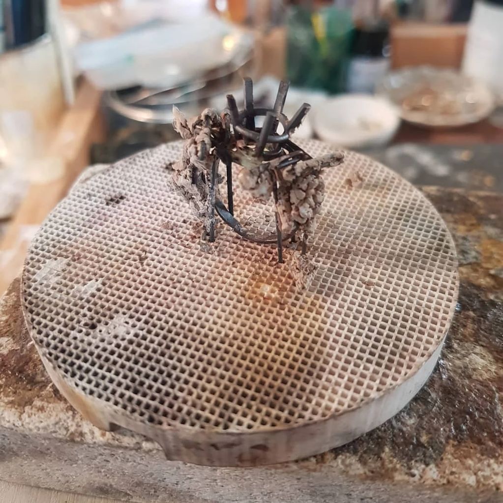 Partially made ring supported on soldering block in a jewellery workshop