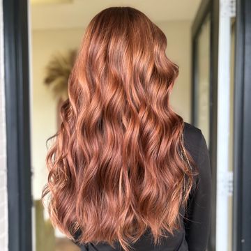 Long, wavy, red hair cascading down the back.