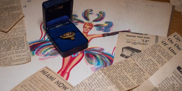 Historical photographs, a photo of Clover Club art, a Miami Attorney pin owned by Olavi