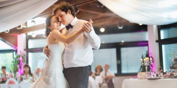 Bride and groom share a romantic dance at their wedding reception.