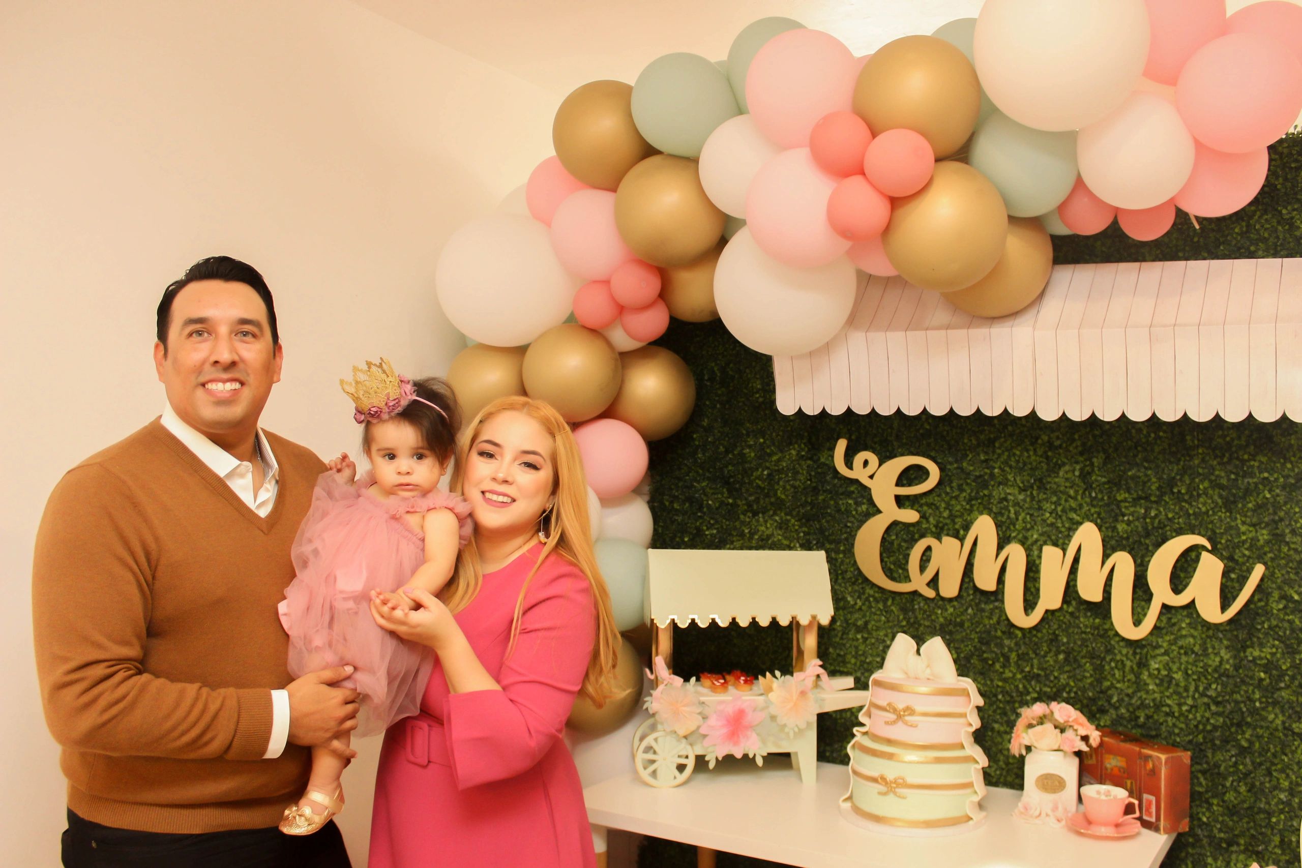 A family celebrates Emma's birthday with balloons and cake.