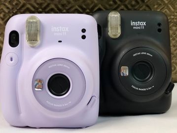 Two Fujifilm Instax Mini cameras.