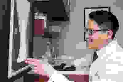 Doctor examining x-rays.
