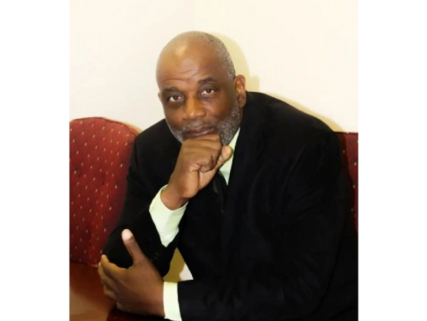 Mr. D. Joiner sitting on a chair looking ahead