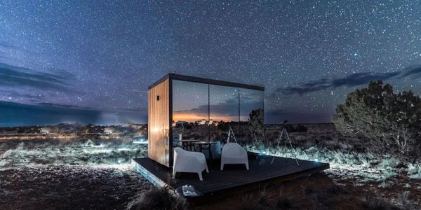 mirrored tiny home at dusk.