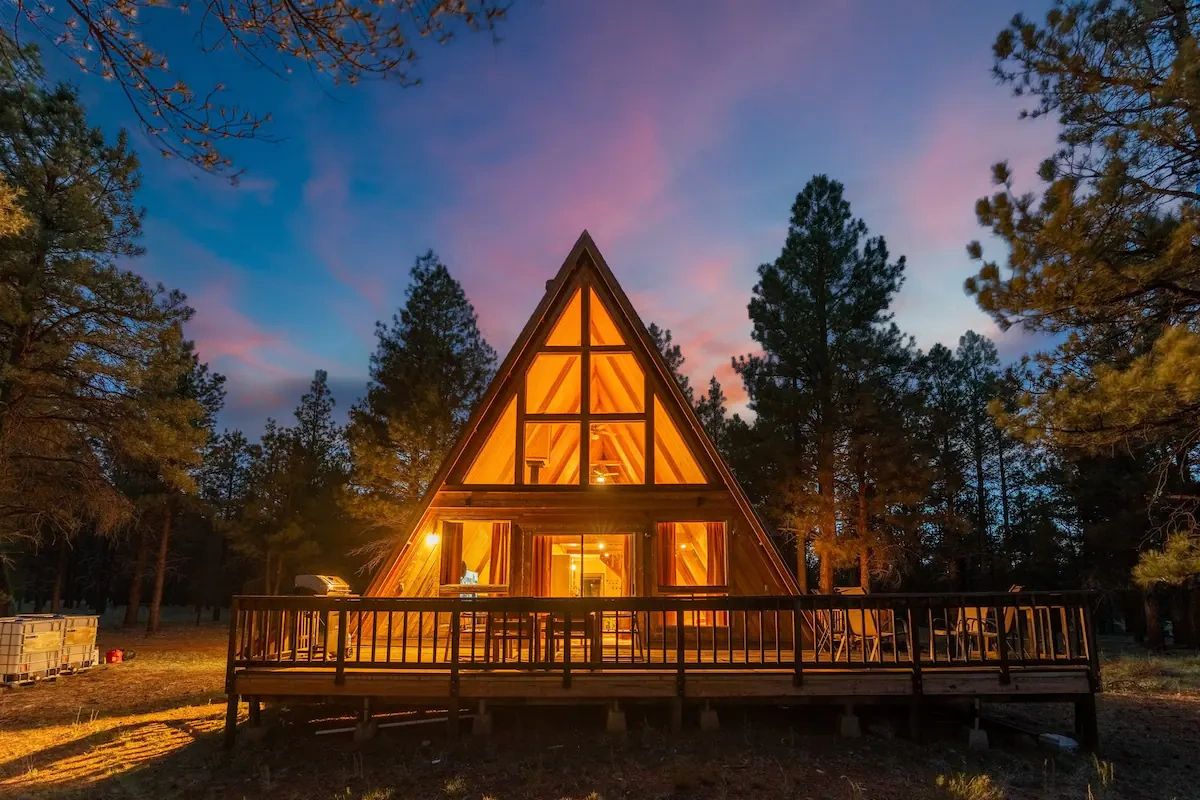 Aframe home lit up at dusk in northern arizona