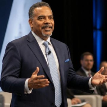 Man speaking confidently at a formal event.