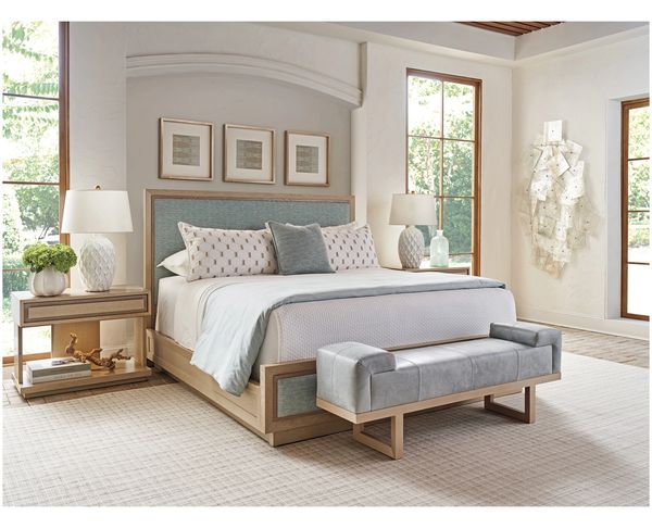 Modern bedroom with a wooden bed, soft bedding, and matching nightstands.