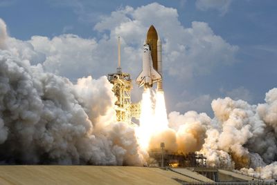 Space shuttle Atlantis launching into the sky.