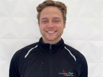 Smiling man in black sports jacket.