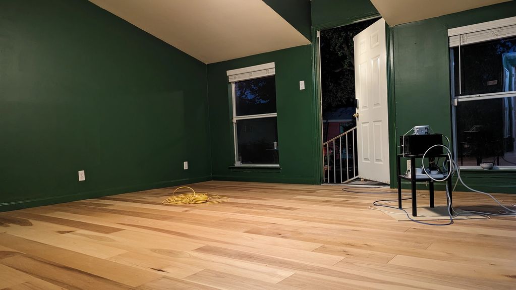 Considerate Handyman image of a room remodel. Walls, Ceiling, and trim painted. Wood Floors Drywall