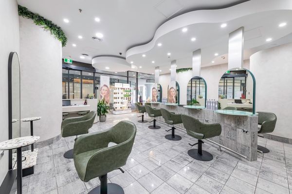 Wide angle shot of beautiful mirrors and seats for haircuts inside Salon