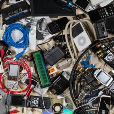 A cluttered assortment of old electronics and cables.