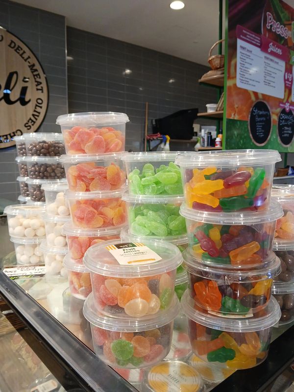 A displays of containers of differnet lollies.